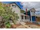 Charming two-story home with a welcoming front porch and mature flowering tree at 1324 Virginia St, Idaho Springs, CO 80452