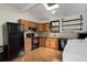 Bright kitchen featuring wood cabinets, appliances, tile backsplash and skylight at 1324 Virginia St, Idaho Springs, CO 80452