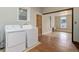 Convenient laundry room with washer, dryer, and wood-look flooring adjacent to open area at 1324 Virginia St, Idaho Springs, CO 80452