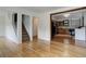 Inviting living room showcasing hardwood floors, open stairway and doorway leading to the kitchen at 1324 Virginia St, Idaho Springs, CO 80452