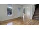 Bright living room featuring hardwood floors, white trim, and staircase access at 1324 Virginia St, Idaho Springs, CO 80452