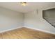 A minimalist living room featuring hardwood floors and access to stairs at 1324 Virginia St, Idaho Springs, CO 80452