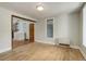 Bright living space with hardwood floors, neutral walls, and an open doorway to a laundry area and kitchen at 1324 Virginia St, Idaho Springs, CO 80452