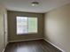Bedroom with laminate flooring, a window providing natural light, and neutral wall color at 4338 N Ceylon Ct, Denver, CO 80249