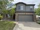 Charming two-story home featuring a gray exterior, brick accents, and a two-car garage at 4338 N Ceylon Ct, Denver, CO 80249