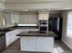 Spacious kitchen featuring stainless steel appliances, granite countertops, and a center island at 4338 N Ceylon Ct, Denver, CO 80249