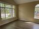 Bright living room with large windows offering natural light and stylish laminate flooring at 4338 N Ceylon Ct, Denver, CO 80249