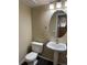Well-lit powder room featuring a pedestal sink and oval mirror at 4338 N Ceylon Ct, Denver, CO 80249