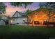 Inviting backyard with a covered patio, string lights, and lush lawn at sunset at 6830 Lamar St, Arvada, CO 80003