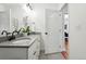 Bright bathroom with double vanity, granite counters, and modern fixtures evokes spa-like luxury at 6830 Lamar St, Arvada, CO 80003