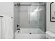 Bathroom featuring a glass-enclosed shower with black fixtures, and a large tub for relaxing at 6830 Lamar St, Arvada, CO 80003