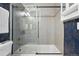 Bathroom featuring floral wallpaper, a shower and tub combination, and silver and gold fixtures at 6830 Lamar St, Arvada, CO 80003