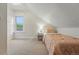 Attic bedroom featuring carpet, a single bed, and lots of light from the window at 6830 Lamar St, Arvada, CO 80003
