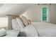 Bedroom featuring a large comfortable bed, soft neutral walls, and natural light from a window at 6830 Lamar St, Arvada, CO 80003
