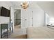 Bright bedroom featuring neutral walls, and carpet with a dresser, side table and chandelier at 6830 Lamar St, Arvada, CO 80003