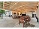 Spacious covered patio featuring string lights, ample seating, a dining table, and a ping pong table at 6830 Lamar St, Arvada, CO 80003