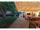 Cozy covered patio with string lights, comfortable seating, and a view of the landscaped backyard at 6830 Lamar St, Arvada, CO 80003