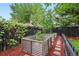 Raised garden beds with a stone path amidst a well-maintained yard at 6830 Lamar St, Arvada, CO 80003