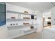 Well-organized laundry room with ample shelving and access to the kitchen offers convenience at 6830 Lamar St, Arvada, CO 80003