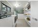 Spacious laundry room with shelving and natural light provides practical storage at 6830 Lamar St, Arvada, CO 80003