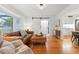 Comfortable living room with hardwood floors, bay window, and stylish furnishings at 6830 Lamar St, Arvada, CO 80003