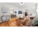 Comfortable living room with a leather ottoman, hardwood floors, and stylish furnishings at 6830 Lamar St, Arvada, CO 80003