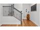 Elegant staircase with dark metal railing and hardwood floors adds character at 6830 Lamar St, Arvada, CO 80003