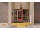 Apartment entrance with a red door and a yellow step at 7755 E Quincy Ave # 207A3, Denver, CO 80237