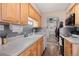 Efficient kitchen showcasing wood cabinets, neutral countertops, and essential appliances at 7755 E Quincy Ave # 207A3, Denver, CO 80237