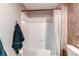 This bathroom has a bathtub with white tile and a shower, and a towel hook for hanging towels at 1651 W Canal Cir # 613, Littleton, CO 80120