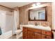 This uniquely designed bathroom features wood-look walls, a sink, a mirror, a tub, and a toilet at 1651 W Canal Cir # 613, Littleton, CO 80120