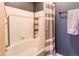 This bathroom has a bathtub with white tile and a shower, and a rod for hanging towels at 1651 W Canal Cir # 613, Littleton, CO 80120