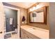 This bathroom offers ample counter space with a single sink and vanity, a toilet, and a shower at 1651 W Canal Cir # 613, Littleton, CO 80120
