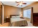 This cozy bedroom features a ceiling fan, natural light from a large window, and soft neutral tones at 1651 W Canal Cir # 613, Littleton, CO 80120