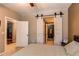 This bedroom has a unique barn door leading to the bathroom and features neutral tones at 1651 W Canal Cir # 613, Littleton, CO 80120