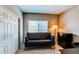 This flexible space could be used as a bedroom, featuring a futon, closet, and a window at 1651 W Canal Cir # 613, Littleton, CO 80120