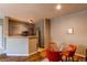 Bright dining area featuring a glass table and orange chairs, perfect for casual dining at 1651 W Canal Cir # 613, Littleton, CO 80120