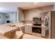 Modern kitchen boasts stainless steel appliances and ample countertop space at 1651 W Canal Cir # 613, Littleton, CO 80120