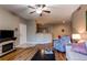 Open-concept living room with modern finishes, including a fireplace and wood floors at 1651 W Canal Cir # 613, Littleton, CO 80120