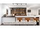 Basement bar with glass shelving and wooden details at 5191 Lions Paw St, Castle Rock, CO 80104