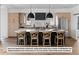 Modern kitchen with light wood cabinets and large island at 5191 Lions Paw St, Castle Rock, CO 80104