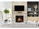 Cozy living room with stone fireplace and built-in shelving at 5191 Lions Paw St, Castle Rock, CO 80104