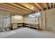 Unfinished basement with exposed beams, work bench, and shelving at 8871 E Amherst Dr # B, Denver, CO 80231