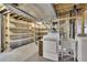 Unfinished basement with exposed beams, utility sink, and laundry machines at 8871 E Amherst Dr # B, Denver, CO 80231