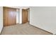 Bedroom featuring wall closet with door and doorway into another room at 8871 E Amherst Dr # B, Denver, CO 80231