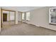 Spacious bedroom featuring mirrored closet doors and a large window at 8871 E Amherst Dr # B, Denver, CO 80231