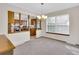 A dining room featuring a chandelier and kitchen view at 8871 E Amherst Dr # B, Denver, CO 80231