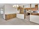 A dining room featuring a chandelier and kitchen view at 8871 E Amherst Dr # B, Denver, CO 80231