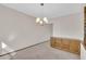 A dining room featuring a chandelier and built in cabinet at 8871 E Amherst Dr # B, Denver, CO 80231