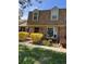 Attractive townhouse with a brick facade, complemented by colorful flowers and lush greenery at 8871 E Amherst Dr # B, Denver, CO 80231